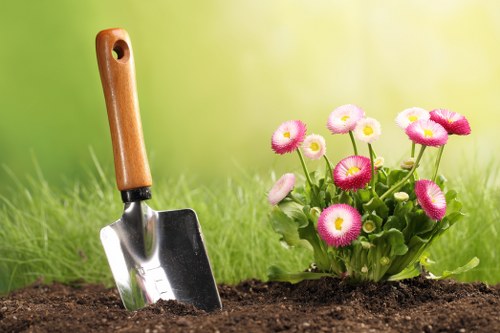 Workers handling garden waste and rubbish safely on site